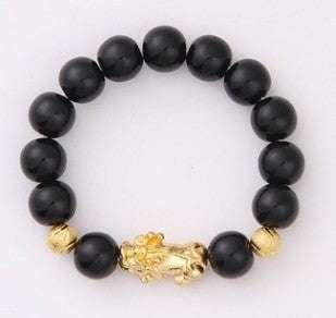 Black beaded bracelet with gold accents and lion charm, modern streetwear accessory