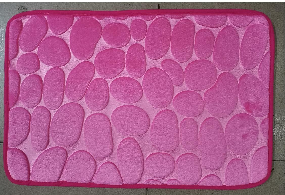 Pink rectangular bath mat with embossed pebble pattern and soft fabric texture