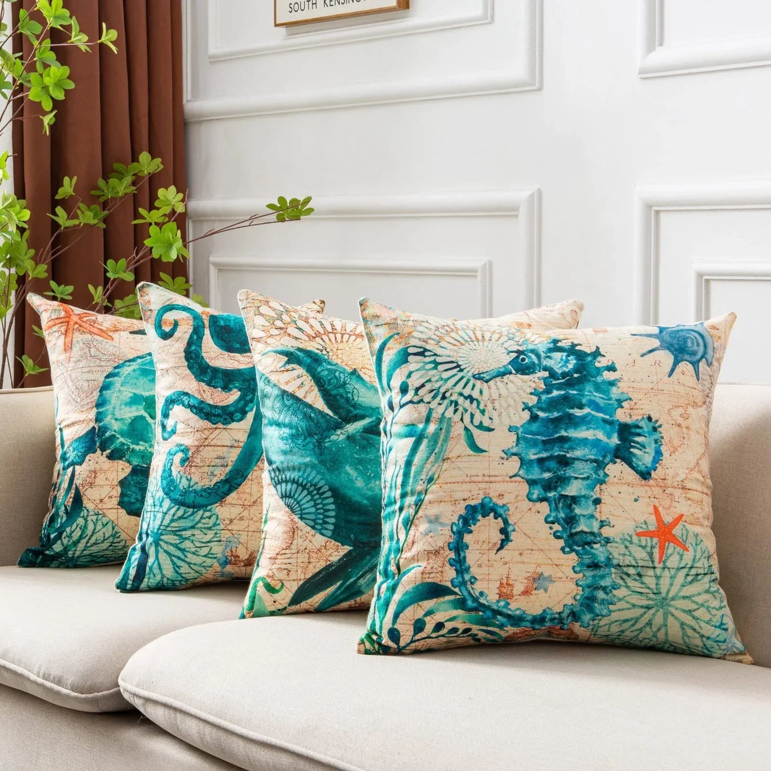 Set of four throw pillows with teal sea creature prints on beige, linen-like fabric, square fit.