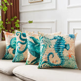 Set of four throw pillows with teal sea creature prints on beige, linen-like fabric, square fit.
