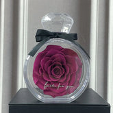 Deep red rose in a clear round case with ribbon, elegant preserved flower decor