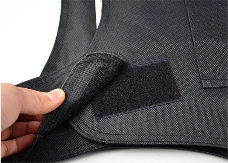 Close-up of black tactical vest with Velcro strap, showcasing durable fabric and adjustable fit