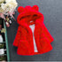 Bright red faux fur hooded jacket with bear ears, plush material, relaxed fit, two pockets.