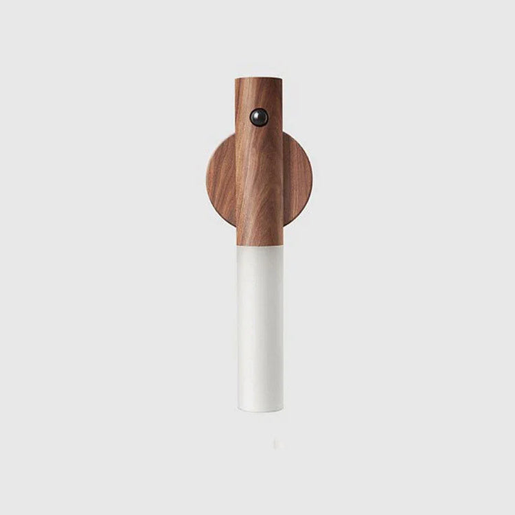 Modern wall light with wood finish and cylindrical frosted glass shade on white background