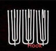 Set of silver metal S-shaped hooks against a black background, minimalist style