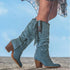 Blue suede knee-high boots with fringe, block heel, and decorative studs, relaxed fit