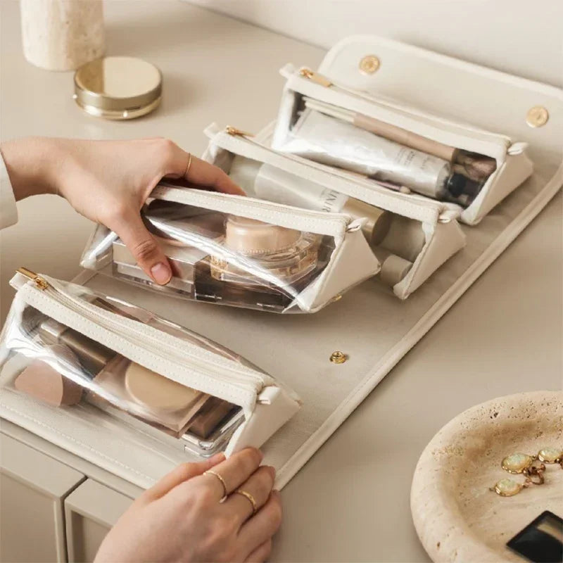 Beige clear makeup pouches with gold zippers, organized on a foldable organizer, modern style