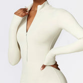 Beige long sleeve zip-up bodysuit, slim fit, seamless stretch fabric, modern activewear style