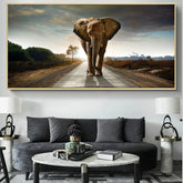 Modern living room with dark gray curved sofa, textured cushions, and round marble coffee table. Minimalist decor.