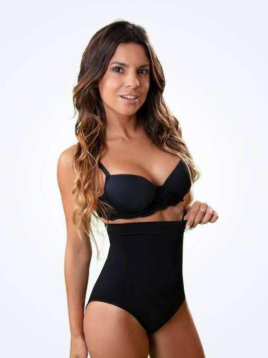 Woman wearing black high-waisted shapewear and bra, slim fit, stretchy fabric