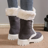 Gray suede winter boots with white faux fur lining and chunky sole, worn with skinny jeans