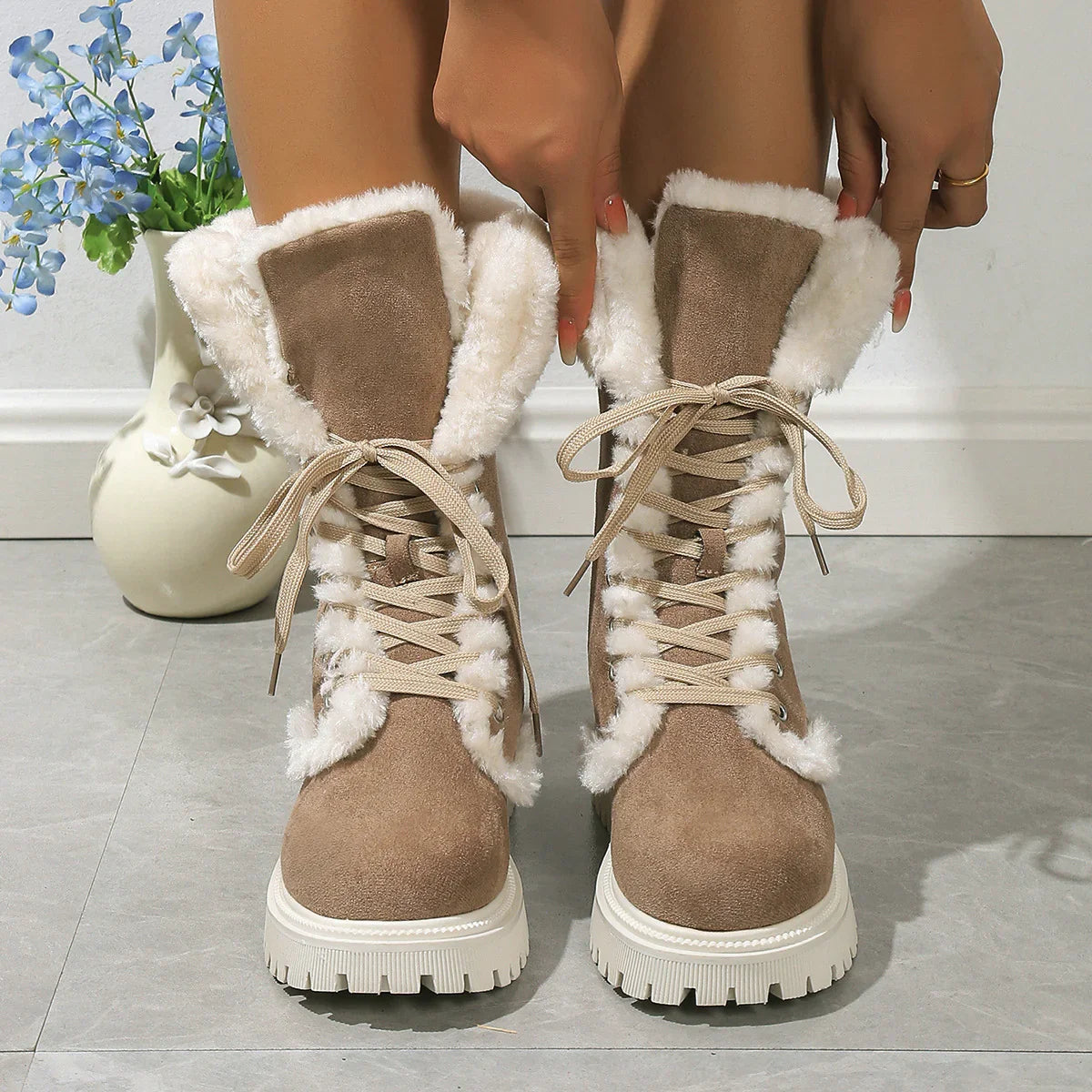 Beige suede lace-up winter boots with white faux fur lining and chunky soles