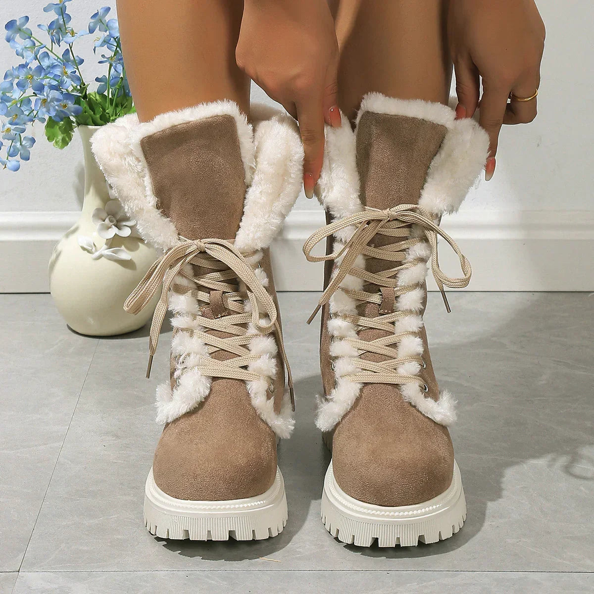 Beige suede lace-up winter boots with white faux fur lining and chunky soles