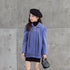 Girl in a loose-fitting light purple wool coat with button details and black beret