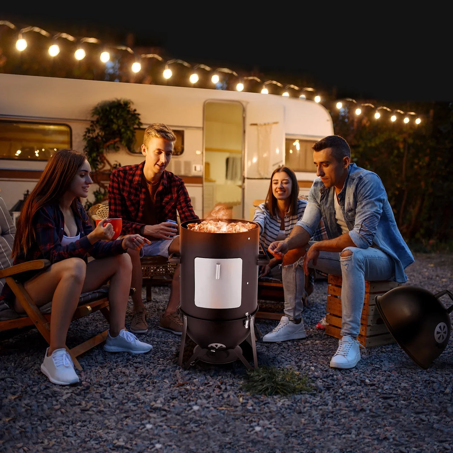 Group wearing casual streetwear, flannel shirts, denim jackets, and sneakers around a fire pit outdoors