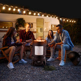 Group wearing casual streetwear, flannel shirts, denim jackets, and sneakers around a fire pit outdoors