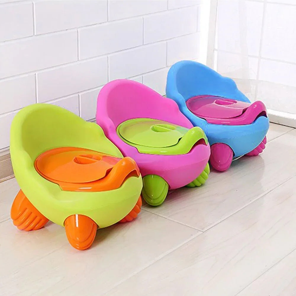 Colorful plastic toddler potty chairs in green, pink, and blue with rounded design