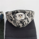 Gray camouflage hooded puffer jacket with dog patch, star accents, and quilted fabric.