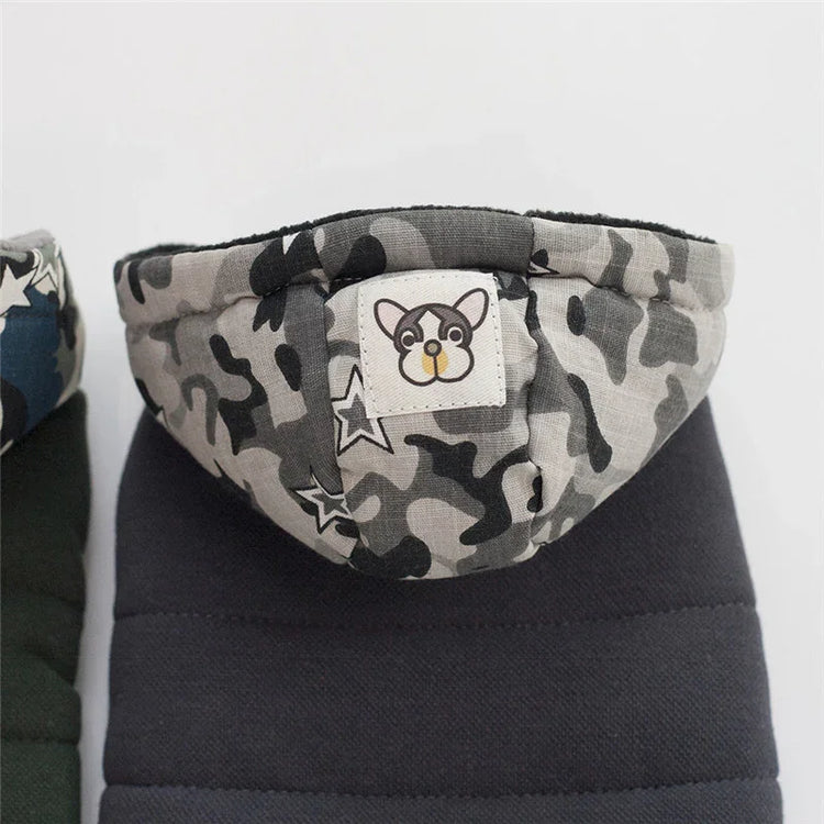 Gray camouflage hooded puffer jacket with dog patch, star accents, and quilted fabric.