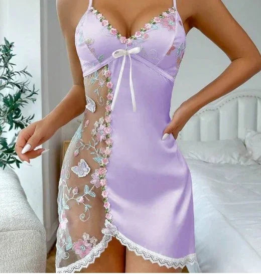 Lilac satin slip dress with sheer floral mesh panel, spaghetti straps, and lace trim.