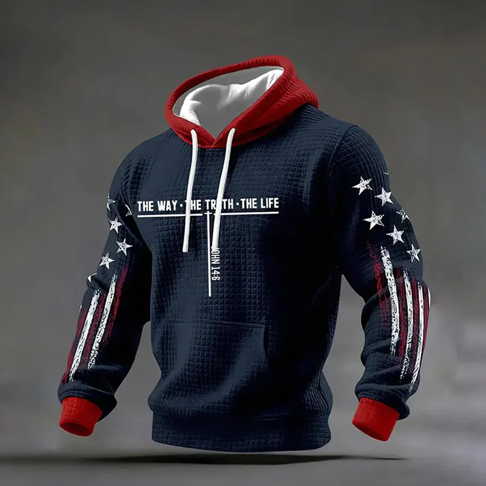 Navy blue waffle-knit hoodie with red hood, white drawstrings, star and stripe sleeve accents, relaxed fit.