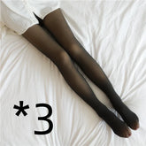 Black sheer tights with a snug fit, worn with a white shirt, displayed on a bed.