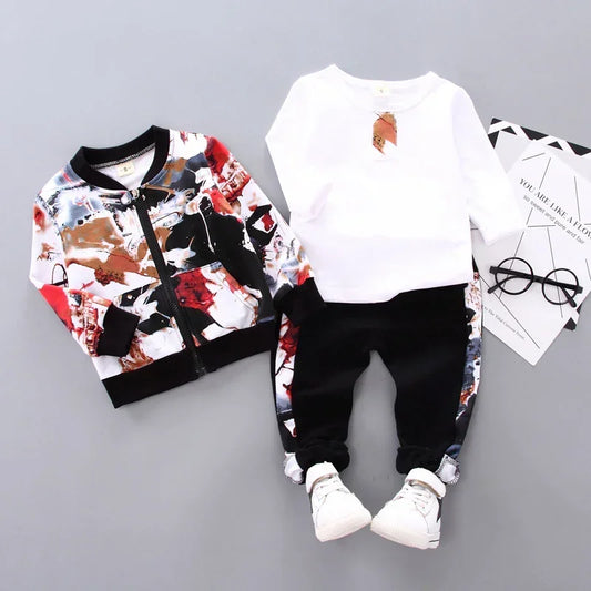 Kids streetwear set with abstract print jacket, white shirt, black pants, and sneakers