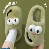 Green fuzzy slippers with cartoon eyes and playful face design, cozy slip-on fit
