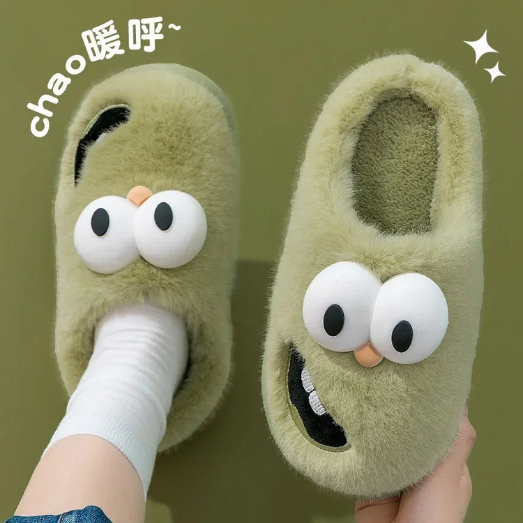 Green fuzzy slippers with cartoon eyes and playful face design, cozy slip-on fit