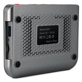 Close-up of metallic tech device with ventilation holes, ports, and textured finish