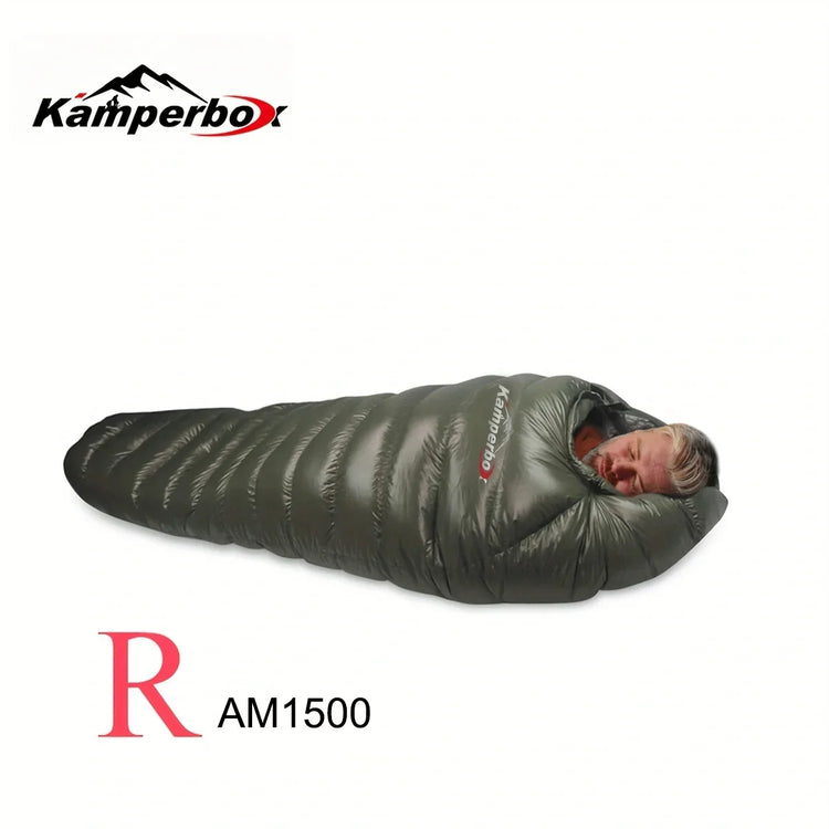 Man in a dark green, puffer-style, mummy-fit sleeping bag with glossy finish