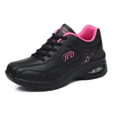 Black leather sneaker with pink trim and cushioned sole, sporty lace-up design
