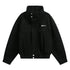 Black oversized streetwear jacket with high collar, snap buttons, chest pockets, and elastic hem.