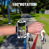 Adjustable black wrist phone holder with 180° rotation worn outdoors on walking path