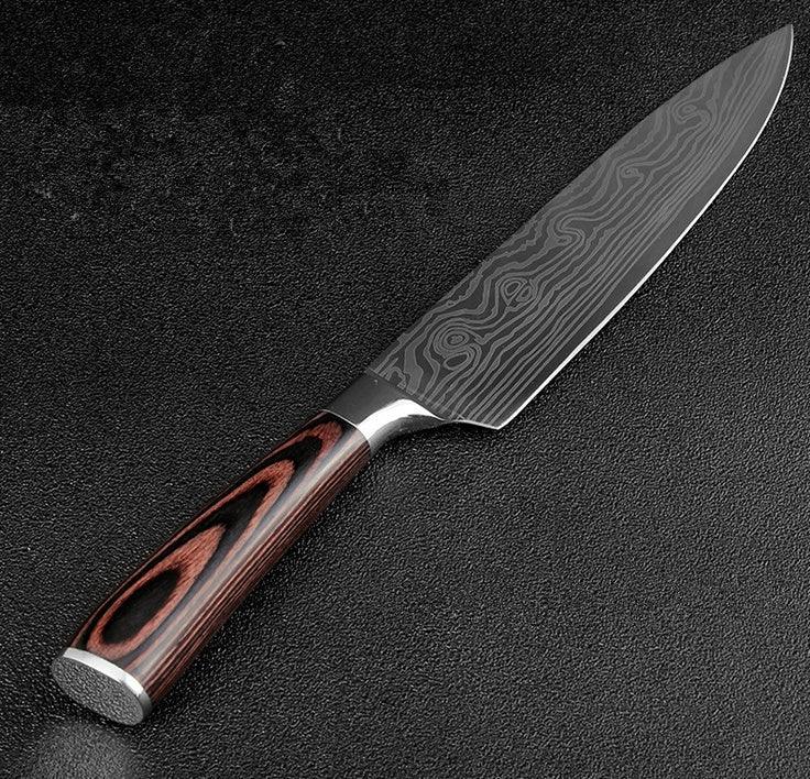 Chef knife with Damascus steel blade and wooden handle on textured black background