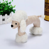 Plush poodle toy with textured beige body, white fluffy ears, tail, and leg cuffs, standing on a white surface.