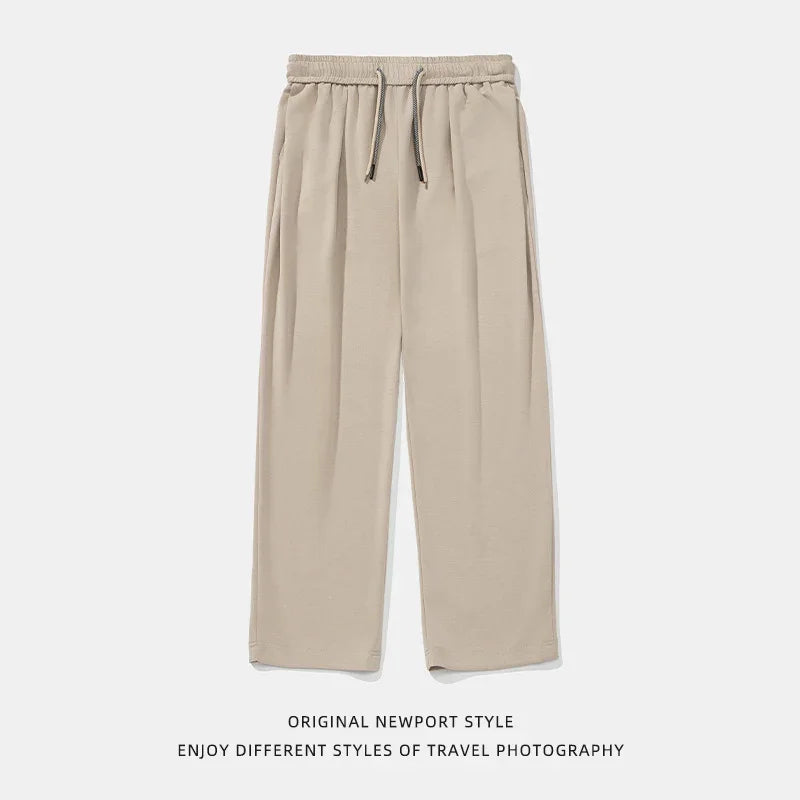 Beige wide-leg lounge pants with elastic waistband and drawstring, relaxed fit, soft fabric.