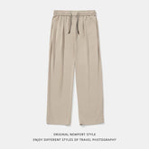 Beige wide-leg lounge pants with elastic waistband and drawstring, relaxed fit, soft fabric.