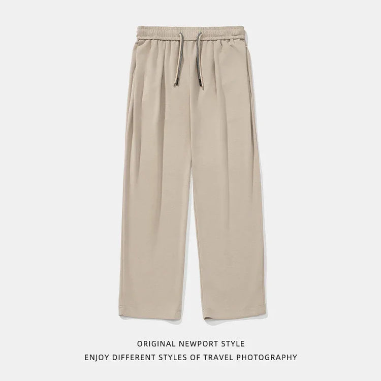 Beige wide-leg lounge pants with elastic waistband and drawstring, relaxed fit, soft fabric.