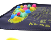 Colorful acupressure foot massage mat with raised plastic nodes on a dark background.
