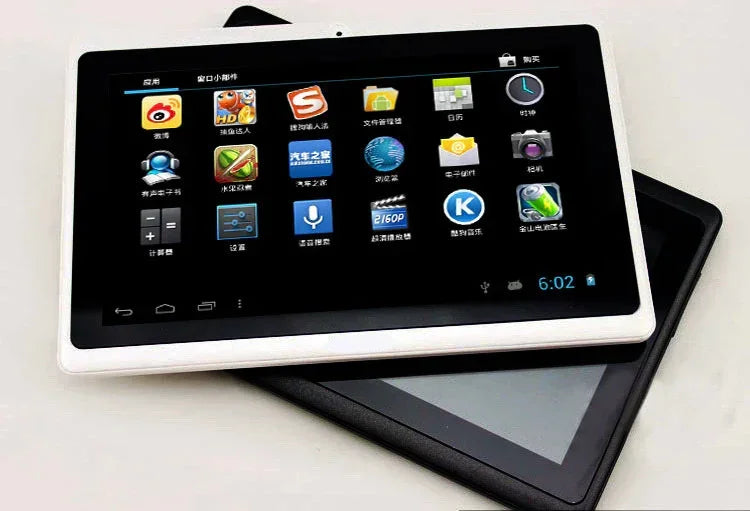 Two touchscreen tablets, one white and one black, displaying app icons on a flat surface.