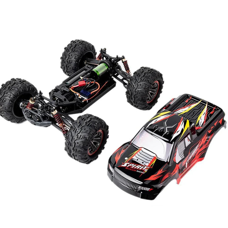 Off-road RC truck with black and red body shell, large rugged tires, and exposed chassis