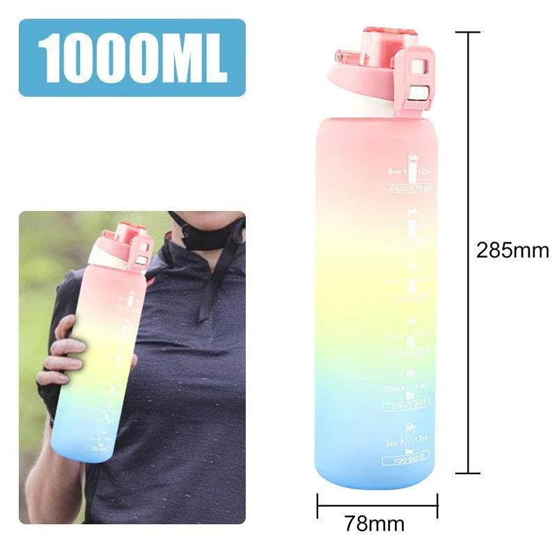 Person wearing a dark athletic shirt holding a pastel gradient water bottle, casual fit.