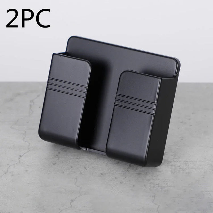 Black wall-mounted holder for tech accessories, modern minimalist design, plastic material.