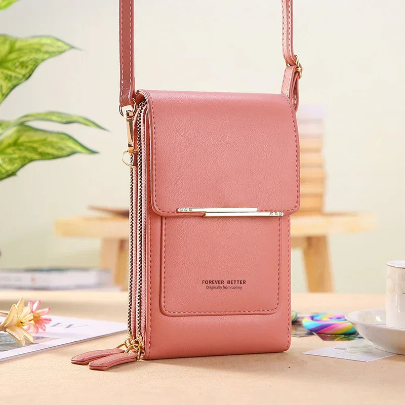Pink faux leather crossbody phone bag with dual zipper pockets and slim fit design