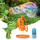 Green dinosaur-shaped bubble gun with orange loop, creating large colorful bubbles outdoors.