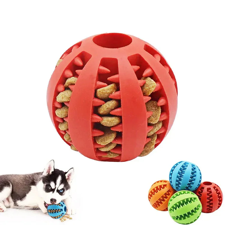 Rubber treat-dispensing ball dog toy in red, shown with kibble and playful puppy.