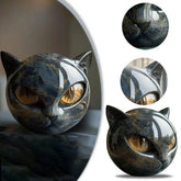 Glossy black and gold cat head sculpture with smooth, reflective surface and abstract design