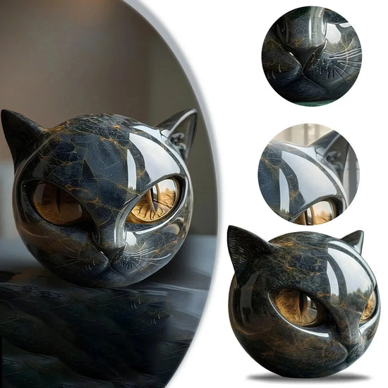 Glossy black and gold cat head sculpture with smooth, reflective surface and abstract design