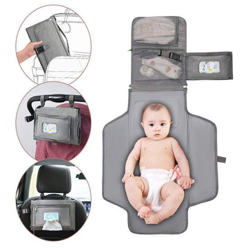 Portable waterproof gray baby changing pad with storage pockets, soft wipeable material, compact foldable design, and adjustable fit for travel or stroller use.